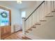 A foyer features an entry door, staircase, hardwood flooring, and a cabinet at 340 President St, Charleston, SC 29403