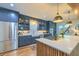 Bright kitchen boasts updated stainless steel appliances, island with seating, and modern white countertops at 340 President St, Charleston, SC 29403