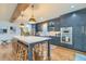 Bright kitchen boasts a large island, stainless appliances, and custom blue cabinets at 340 President St, Charleston, SC 29403