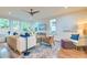 Bright living room with hardwood floors, large windows, a ceiling fan, and comfortable seating at 340 President St, Charleston, SC 29403