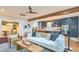 An open-concept living room boasts hardwood floors, wood beams, and stylish furniture at 340 President St, Charleston, SC 29403