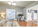 Stylish living room featuring a modern desk setup, hardwood floors, and an open doorway showcasing the staircase at 340 President St, Charleston, SC 29403