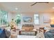 Airy living room featuring a decorative ceiling fan, bright natural light, and hardwood floors at 340 President St, Charleston, SC 29403