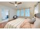 Comfortable primary bedroom with hardwood floors, a ceiling fan, and shuttered windows at 340 President St, Charleston, SC 29403