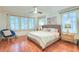 Airy primary bedroom with hardwood floors, a ceiling fan, and natural light at 340 President St, Charleston, SC 29403
