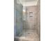 Shower featuring neutral tiles, a glass door and built in shelving niche at 340 President St, Charleston, SC 29403