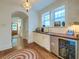 Charming wet bar with stylish cabinets, countertop, beverage fridge, and modern fixtures at 340 President St, Charleston, SC 29403