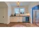 Elegant wet bar with modern lighting, stainless steel beverage cooler, and built-in sink at 340 President St, Charleston, SC 29403