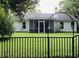 Backyard view showcasing a screened-in porch and a fenced yard at 3415 Pawtucket St, Charleston, SC 29414