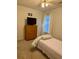 This well-lit bedroom showcases a dresser next to the window and a comfortable bed at 3415 Pawtucket St, Charleston, SC 29414