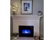 Living room fireplace with electric blue flames and a white mantle at 3415 Pawtucket St, Charleston, SC 29414