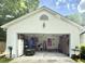 Garage exterior featuring an open door, storage, and tools at 3415 Pawtucket St, Charleston, SC 29414