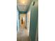 Hallway with blue walls, carpeted floor, and several doorways at 3415 Pawtucket St, Charleston, SC 29414
