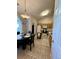 Eat-in kitchen with tiled floors, wooden cabinets and bright light fixture above the table at 3415 Pawtucket St, Charleston, SC 29414