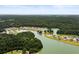 Stunning aerial view of houses along a winding river, surrounded by a dense forest at 3431 Great Egret Dr, Johns Island, SC 29455