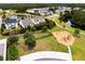 Aerial view of the community playground near pond and homes with manicured lawns at 3431 Great Egret Dr, Johns Island, SC 29455