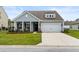 Charming one-story home features a gray exterior, landscaped yard, and a two-car garage at 3431 Great Egret Dr, Johns Island, SC 29455