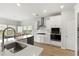 Bright kitchen features white cabinets, stainless steel appliances, and a large island with quartz countertops at 3431 Great Egret Dr, Johns Island, SC 29455