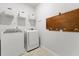 Bright laundry room with white appliances and storage, ready for your convenience at 3431 Great Egret Dr, Johns Island, SC 29455