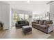 Bright living room features neutral decor, large windows, and open access to the kitchen at 3431 Great Egret Dr, Johns Island, SC 29455