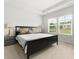 Serene main bedroom with neutral tones, tray ceiling, and large windows for natural light at 3431 Great Egret Dr, Johns Island, SC 29455