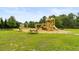 Community playground with swings, slides, and picnic table in a grassy area at 3431 Great Egret Dr, Johns Island, SC 29455