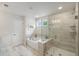 Elegant bathroom with a soaking tub, glass-enclosed shower, and sleek tile work at 4007 Oxeye, Johns Island, SC 29455