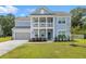 Charming two-story home with a welcoming front porch and manicured lawn on a sunny day at 4007 Oxeye, Johns Island, SC 29455