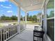 Inviting front porch with white columns and a comfortable bench for relaxation at 4007 Oxeye, Johns Island, SC 29455