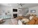 A comfortable living area with a fireplace, modern furniture, hardwood flooring, and natural light at 4007 Oxeye, Johns Island, SC 29455