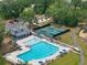Aerial view of a neighborhood pool, tennis courts, playground and parking area surrounded by lush greenery at 4007 Oxeye, Johns Island, SC 29455