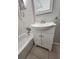 Bathroom featuring a classic white sink with storage below and a bathtub to the left at 4029 Karen Dr, North Charleston, SC 29405