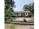 Charming brick home featuring manicured landscaping and mature trees in a desirable neighborhood at 4029 Karen Dr, North Charleston, SC 29405