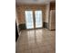Kitchen with double doors leading to the backyard and featuring tile flooring and a white refrigerator at 4029 Karen Dr, North Charleston, SC 29405