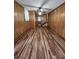 Spacious living room featuring wood paneling and a staircase in the background at 4029 Karen Dr, North Charleston, SC 29405