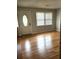 Bright living room featuring gleaming hardwood floors, a decorative front door and natural light at 4029 Karen Dr, North Charleston, SC 29405