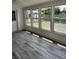 Sunroom featuring vinyl flooring and a wall of windows overlooking the backyard at 4029 Karen Dr, North Charleston, SC 29405