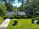 Aerial view of a lovely home with a lush green lawn and mature trees at 411 Dogwood Circle, Summerville, SC 29485