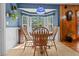 Bright dining area with a wooden table, patterned blue walls, large window, and hardwood floors at 411 Dogwood Circle, Summerville, SC 29485