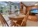 Cozy dining area with a wooden table, large window, and access to the living room and backyard at 411 Dogwood Circle, Summerville, SC 29485