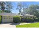 Home exterior with a two-car garage, well-maintained lawn, and inviting landscaping at 411 Dogwood Circle, Summerville, SC 29485
