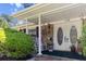 Inviting front porch with double doors, rocking chairs, and brick accents at 411 Dogwood Circle, Summerville, SC 29485