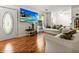 Inviting living room with hardwood floors, white sofa, a TV, and lots of natural light at 411 Dogwood Circle, Summerville, SC 29485