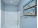 Bright bathroom featuring a shower-tub combination and coastal-themed art for a relaxing ambiance at 414 Hamlet Cir, Goose Creek, SC 29445