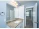 Bathroom vanity with granite counters, white cabinets, and a wall mirror at 414 Hamlet Cir, Goose Creek, SC 29445