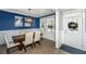 Dining room with wainscoting, stylish light fixture, and an entryway providing a welcoming ambiance for gatherings at 414 Hamlet Cir, Goose Creek, SC 29445