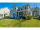 Charming two-story home with a manicured lawn and inviting front porch perfect for enjoying the outdoors at 414 Hamlet Cir, Goose Creek, SC 29445