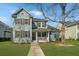 Inviting two-story home with a charming front porch, detailed trim, and beautiful landscaping at 414 Hamlet Cir, Goose Creek, SC 29445