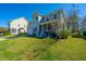 Lovely two-story home with a well-kept lawn, an attached garage, and a cozy front porch at 414 Hamlet Cir, Goose Creek, SC 29445