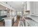 Bright kitchen with granite countertops, white cabinets, stainless steel appliances, and open floor plan into the dining area at 414 Hamlet Cir, Goose Creek, SC 29445